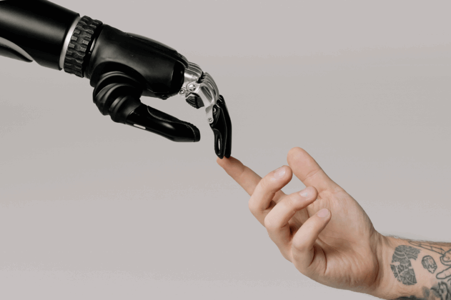 Robotic hand and human hand reaching out to each other, symbolizing AI and human collaboration for business growth