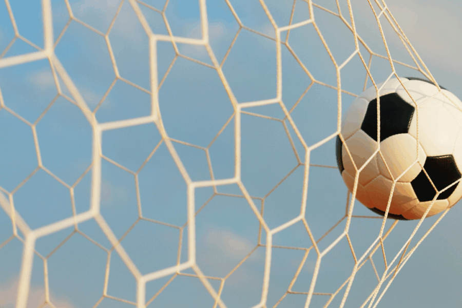Soccer ball hitting the net, symbolizing intentional goal setting and achieving clearly defined goals